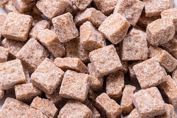Close up Organic Dark Brown Sugar Cubes, textured background