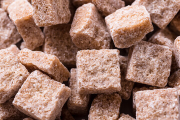 Close up Organic Dark Brown Sugar Cubes, textured background
