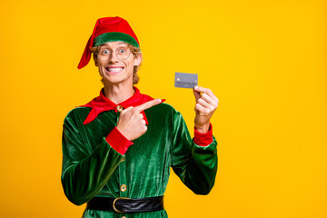 Portrait of his he nice attractive cheerful glad funny guy elf holding in hands demonstrating bank...