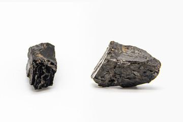 Natural black coals isolated in white background. Two dirty coals stones.