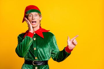 Portrait of his he nice attractive amazed stunned cheerful cheery funny guy elf demonstrating copy space wow advice solution isolated over bright vivid shine vibrant yellow color background