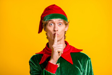 Close-up portrait of his he nice attractive childish cheery funny guy elf showing shh sign Eve Noel...