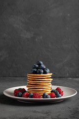 Pancakes with berries and maple syrup. Delicious Pancakes with raspberries and blueberries.