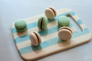 
light blue and natural macarons on scratched ceramic table on white background
