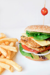 A vegan burger with vegetables and tomato

