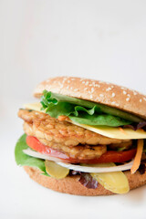 A vegan burger with vegetables and tomato

