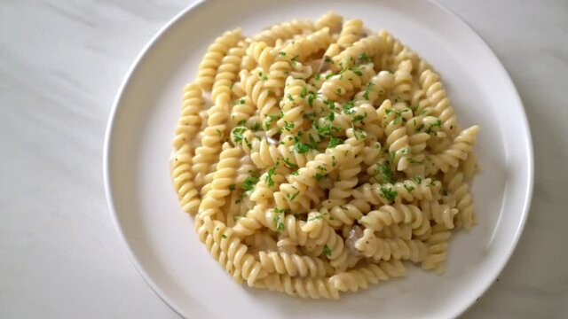 spirali or spiral pasta mushroom cream sauce with parsley - Italian food style