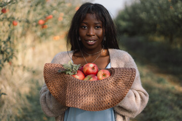 Portrait Afro woman in Apple Orchard. African ethnicity. Lifestyle