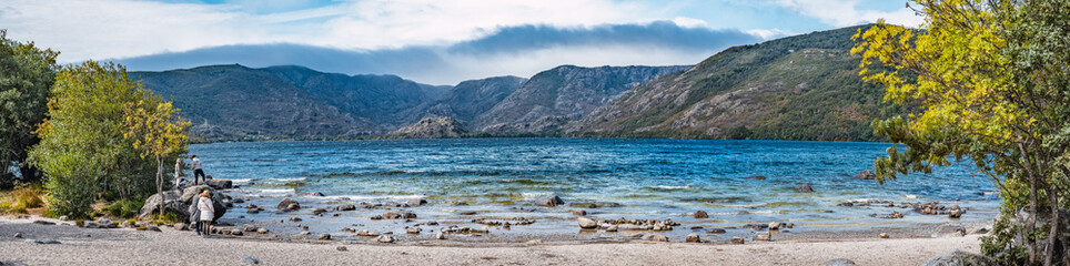 Panoramic view of mountain lake with mountains in the background