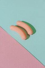 Breakfast ingridients like sausages on pink and blue background. Creative concept. Plastic pop art isometric style. Minimalism