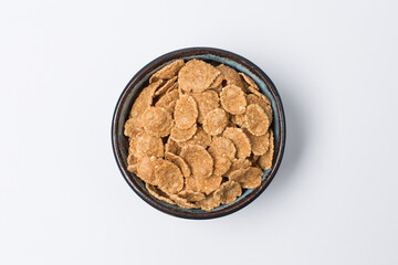 Multigrain flakes in a bowl on white
