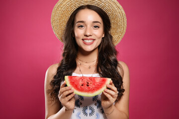 Beautiful young woman with watermelon on pink background