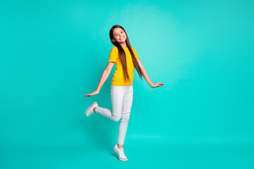 Fototapeta na wymiar Full length photo of pretty kid girl standing isolated over turquoise color background