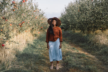 Portrait Afro woman in Apple Orchard. African ethnicity. Lifestyle