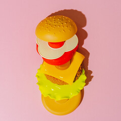 Burger ingredients on pink background. Creative concept. Plastic pop art style. Minimalism