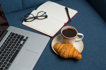 Working from home, on sofa coffee, croissant