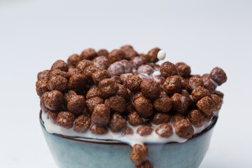 Chocolate corn balls in bowl on white