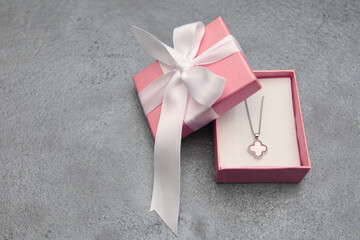 The perfect piece of jewelry for a perfect holiday! gift box with red ribbon and bow, Jewelry in a...