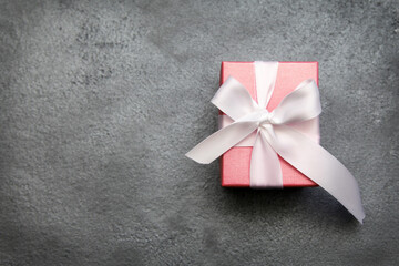 The perfect piece of jewelry for a perfect holiday! white gift box with ribbon, Jewelry in a pink...