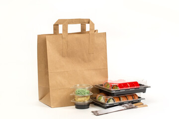 Food delivery concept, sushi in plastic container delivered to home