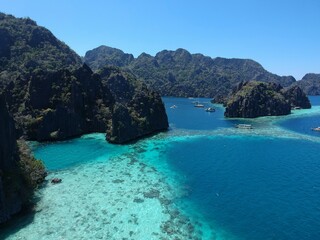 Fototapeta premium drone view of the open sea, coral reef, diving and snorkeling area, limestone rocks, Philippine boats in Coron Palawan