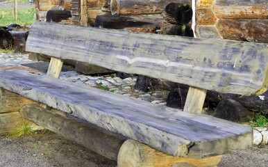 an old wooden bench stands on the territory of the temple