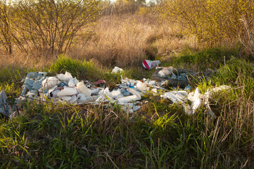 Environmental pollution. Garbage dump in the field. Illegal garbage dump