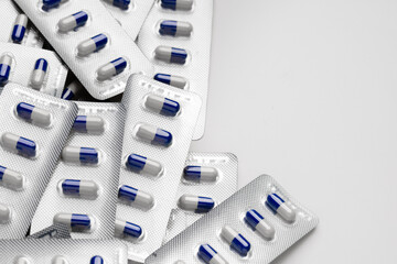 Blue and white capsule pills in blister packs