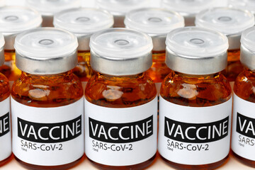 Sars-cov-2 vaccine vial bottles on white table