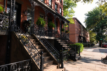 Row of Beautiful Old Brick Homes along a Sidewalk in Hamilton Park of Jersey City