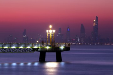 Skyline of Kuwait City at sunset with pier