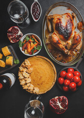 Thanksgiving party table with turkey, vegetables and pumpkin pie