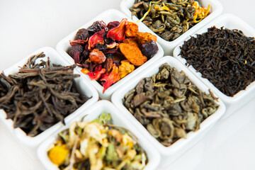Assortment of dry tea. Various kinds of tea isolated on white.Different kinds of tea leaves. Tea composition with different kind of tea. Tea concept. Tea leaves