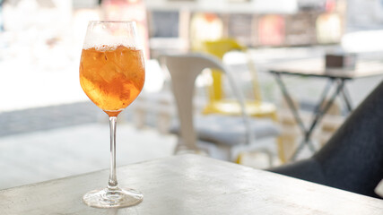 Cocktail aperol spritz in cafe. Aperol Spritz Cocktail. Alcoholic beverage in hand on bright background.