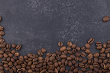 Brown coffee bean isolated on dark background.