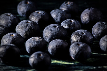 Macro shot of blueberries on dark background with side light