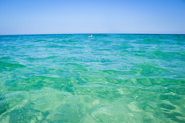 Calm sea, blue water, sky and horizon scene in Tunisia.