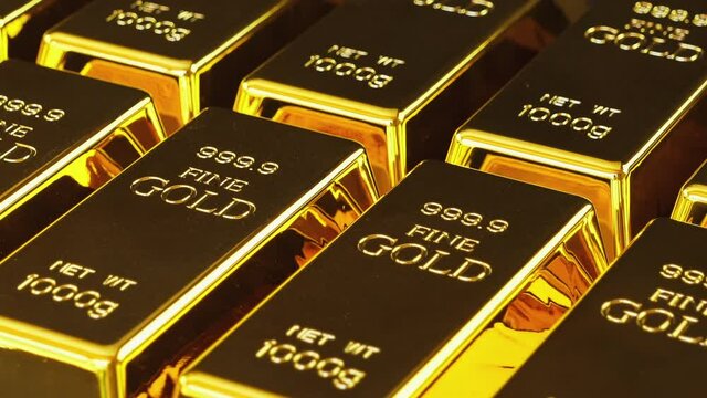 Gold bars stacked in a row. Gold bricks. Stack of gold bullion bars. Seamless looping footage. The camera pans around gold bars in close up.