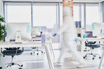 Unrecognizable person in protective workwear walking through the office