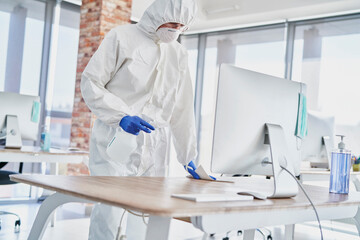 Spraying disinfection on surface in the office