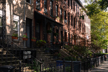 Row of Beautiful Old Brick Homes along a Sidewalk in Hamilton Park of Jersey City