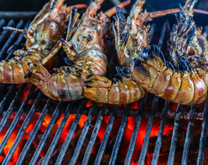 Cooking fried king prawns seafood on fire
