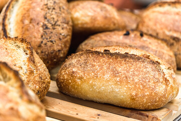 Various rustic bread on a wooden board. Healthy food and farming concept
