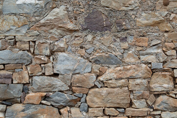 Photo of an ancient wall in Greece. Background of the old masonry. Vertical orientation.