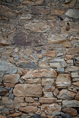 Fototapeta premium Photo of an ancient wall in Greece. Background of the old masonry. Vertical orientation.