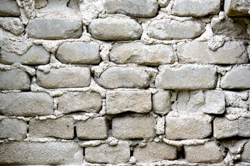 Old brick wall. Ancient stone texture background. Urban background, white ruined industrial brick wall with copy space. Home and office design backdrop. Vintage effect. Beige and gray light colors