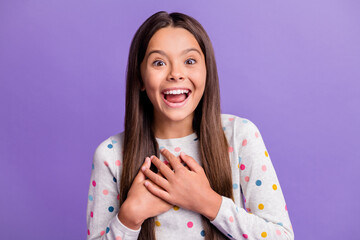 Fototapeta na wymiar Photo portrait of laughing girl touching chest with hands isolated on vivid violet colored background