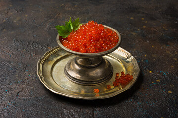 Delicious red caviar of salmon fish in vintage silver dish