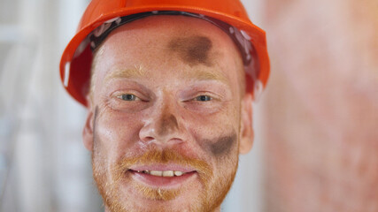 Portrait of male construction worker on building site wearing hard hat