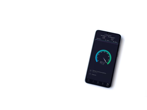 Lod, Israel - July 8, 2020: Speedtest app launch screen with logo on the display of a black mobile smartphone isolated on white background. Top view flat lay with copy space.